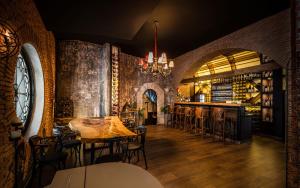 a dining room with a table and chairs and a bar at Amelius Pool Apartments in Caesar Resort SPA, Long Beach in Perivolia tou Trikomou
