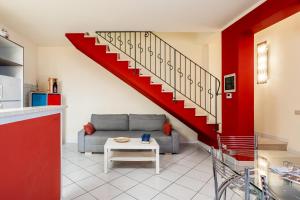 a living room with a couch and a staircase at La Casina Gialla Independent House in Lucca