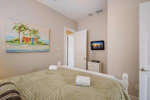 a bedroom with a bed and a painting on the wall at Margarita-Ville in Holmes Beach +49 photos