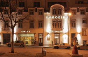a building with cars parked in front of it at Hotel Bagoeira in Barcelos