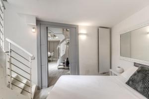 a white bedroom with a bed and a mirror at Elegant flat in the Historic Rome near Colosseum! in Rome +47 photos