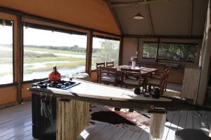 a kitchen and dining area of a house with a table at Kubu & Kwena Lodge in Katima Mulilo