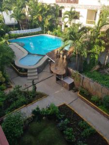 an overhead view of a swimming pool in a garden at Luxury 4BR Apartment with Pool behind Alona Beach in Panglao