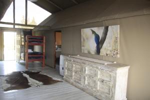 a room with a painting of a bird on the wall at Kubu & Kwena Lodge in Katima Mulilo