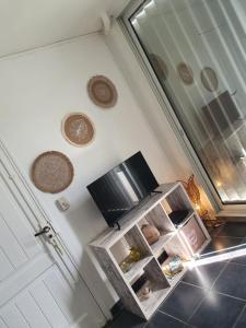 TV o dispositivi per l'intrattenimento presso Appartement face à la mer 2 chambres