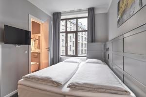 A bed or beds in a room at Four Points Flex by Sheraton Copenhagen City
