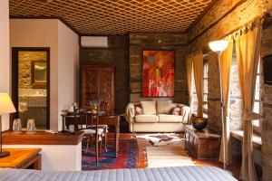 a living room with a couch and a table at Palio Eleotrivio Guesthouse in Agios Lavrentios