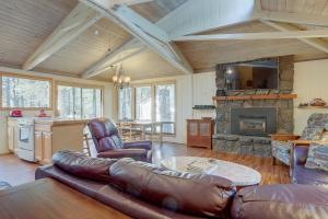 a living room with a leather couch and a fireplace at 11 Pine Mt in Sunriver