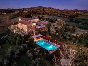 an aerial view of a house with a swimming pool at La Pieve di San Giovanni Luxury Retreat & Spa in Lustignano