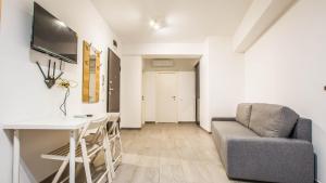 a living room with a couch and a table at Complex panoramic Mihai Bravu cu internet de mare viteza si parcare gratuita in Bucharest