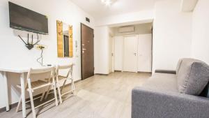 a living room with a couch and a table and a tv at Complex panoramic Mihai Bravu cu internet de mare viteza si parcare gratuita in Bucharest