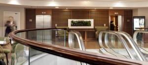 a lobby with chairs and a table in a building at Stamford Bridge Hotel London in London