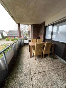 a patio with a table and chairs on a balcony at Apartment Ruhepause II Ruhig & Komfortabel in Bad Bentheim