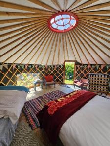a room with a bed in a yurt with a window at Granville House Glamping in Ballyferriter +47 photos