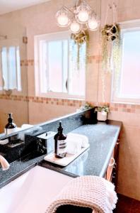 a bathroom with a black counter and a sink at Del Mar Coastal Haven in San Diego +10 photos