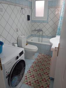 a washing machine in a bathroom with a toilet at JULIA'S APARTMENT in Igoumenitsa +28 photos