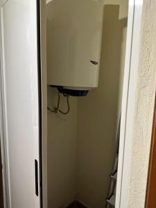 a door to a room with a cabinet in a hallway at Casa caramujo in Quesada +19 photos