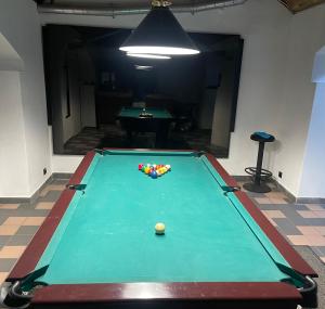 a pool table with a ball on top of it at Flat with spa in center of Riga in Rīga