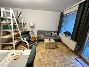 a living room with a couch and a chair at Kleine Oase am Mittellandkanal in Hannover