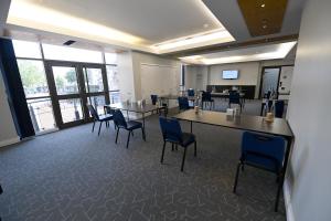 a conference room with tables and chairs in a building at Stamford Bridge Hotel London in London