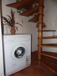 a washing machine with a plant on top of it at Casa do Forno in Valezim
