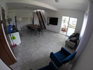 an overhead view of a living room with a table and chairs at Casa Brisa Nordeste in Palhoça