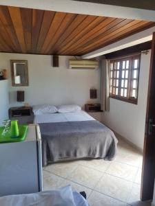 En eller flere senge i et værelse på Chalés e suíte Ilhabela