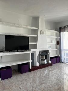 a living room with a tv and a fireplace at La casa de Elisabeth in Nerja