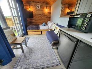 a room with a bedroom with a bed and a kitchen at M Lodge in Colchester