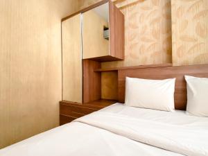 Postel nebo postele na pokoji v ubytování Cozy and Minimalist 2BR at Mutiara Bekasi Apartment By Travelio