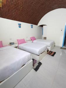 Una cama o camas en una habitación de malindy KA nubian houseماليندى كا 154 fotos más
