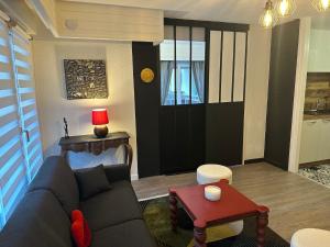 a living room with a couch and a table at Loft HATISAS in Brides-les-Bains