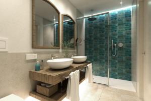 a bathroom with two sinks and a shower at Almar Timi Ama Resort & Spa in Villasimius
