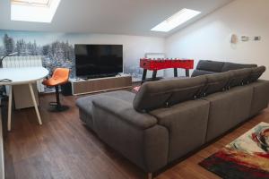 a living room with a couch and a flat screen tv at Matilde's Luxury Villa in Isernia