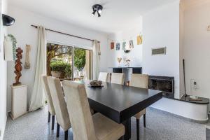 a dining room with a black table and chairs at Chilling In Lagos House Retreat by Algarve Golden Properties in Lagos