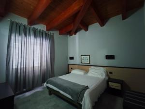 a bedroom with a bed and a large window at Hotel Quadrifoglio in Pontecagnano