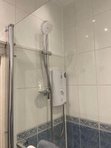 a shower with a shower head in a bathroom at The Lothian Road Residence in Edinburgh +23 photos