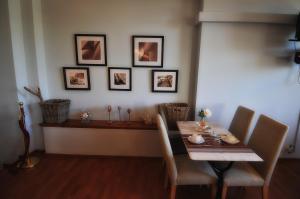 a dining room with a table and some pictures on the wall at Hotel Santa Maria in Saint-Florent