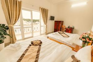 Postel nebo postele na pokoji v ubytování Lê Mùi Hotel - Apartment + 37 fotografií