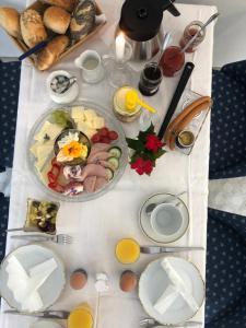 a table with breakfast foods on a white table cloth at Alte Leimsiederei in Herrnhut