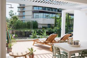 a patio with a table and chairs and a building at Madeira Precious Penthouse in Funchal +40 photos