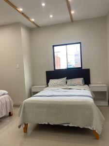 a bedroom with a large bed with a window at Casa Apartament Paseo Del Mar in Chimbote