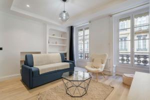 a living room with a blue couch and a chair at Superb apartment in the heart of the peninsula - Air-conditioned in Lyon