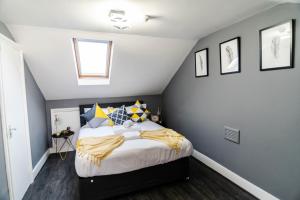 a bedroom with a large bed in a attic at Quiet Top-Floor Retreat -Modern Studio for 2 - Islington in London