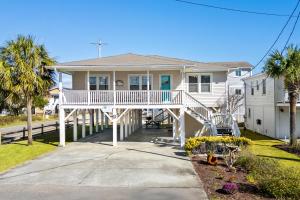 a white house with a porch with a white deck at Sand Dollar- Approx 387 Feet to the Beach in Myrtle Beach