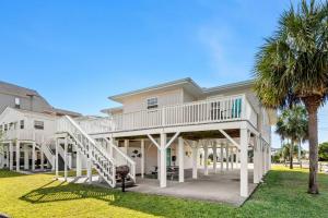 a large house with a porch and stairs at Sand Dollar- Approx 387 Feet to the Beach in Myrtle Beach