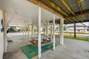a picnic table under a pavilion on a patio at Sand Dollar- Approx 387 Feet to the Beach in Myrtle Beach