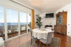 a dining room with a table and a view of the ocean at Perla Marina Sea View Apartment in Catania