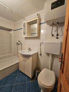 a bathroom with a sink and a toilet and a tub at House Kučija Old town Korčula in Korčula +32 photos