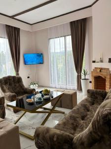 a living room with a couch and a table at MM HOUSE Stepanavan in Stepʼanavan +13 photos
